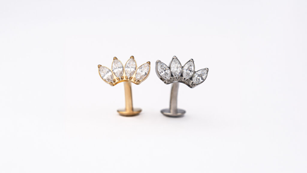 NOXA titanium piercing with marquise-cut zirconia, available in a silver or gold finish.