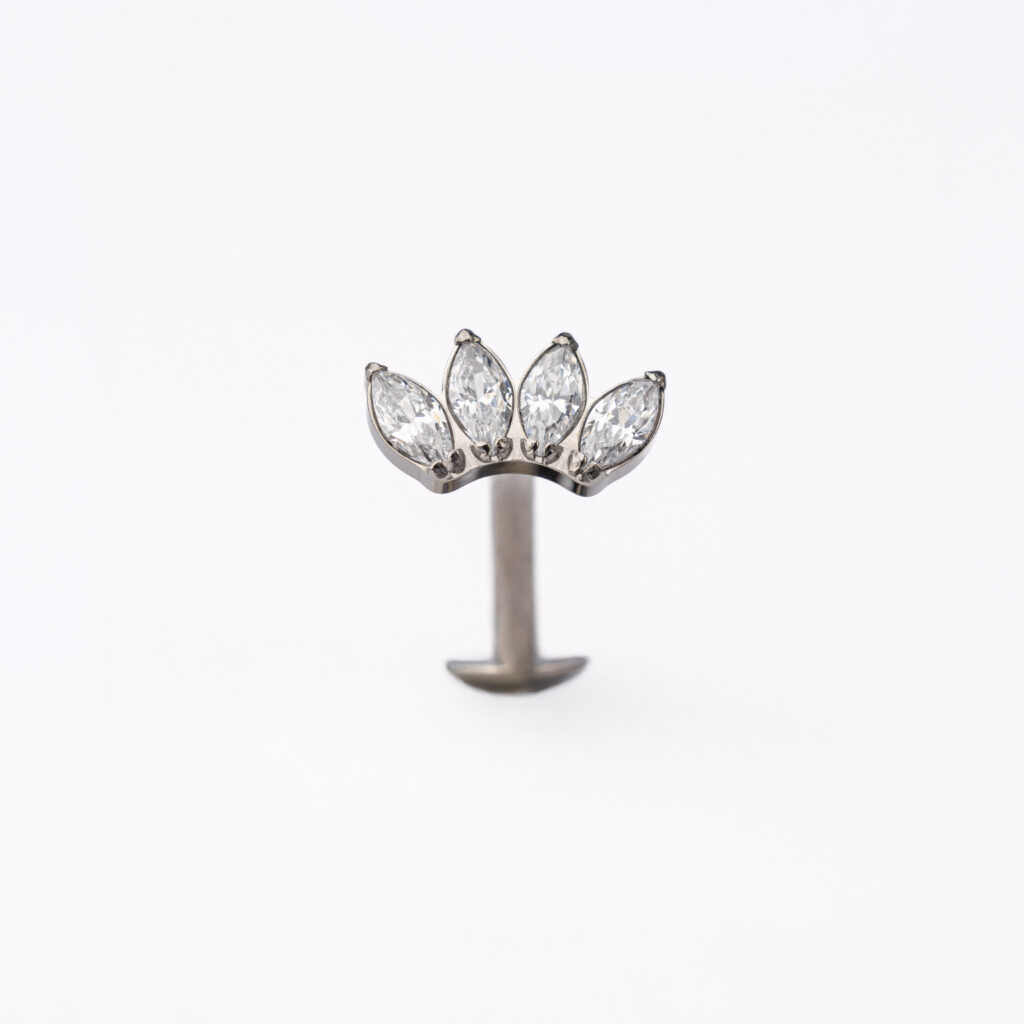 NOXA titanium piercing with marquise-cut zirconia, available in a silver or gold finish.